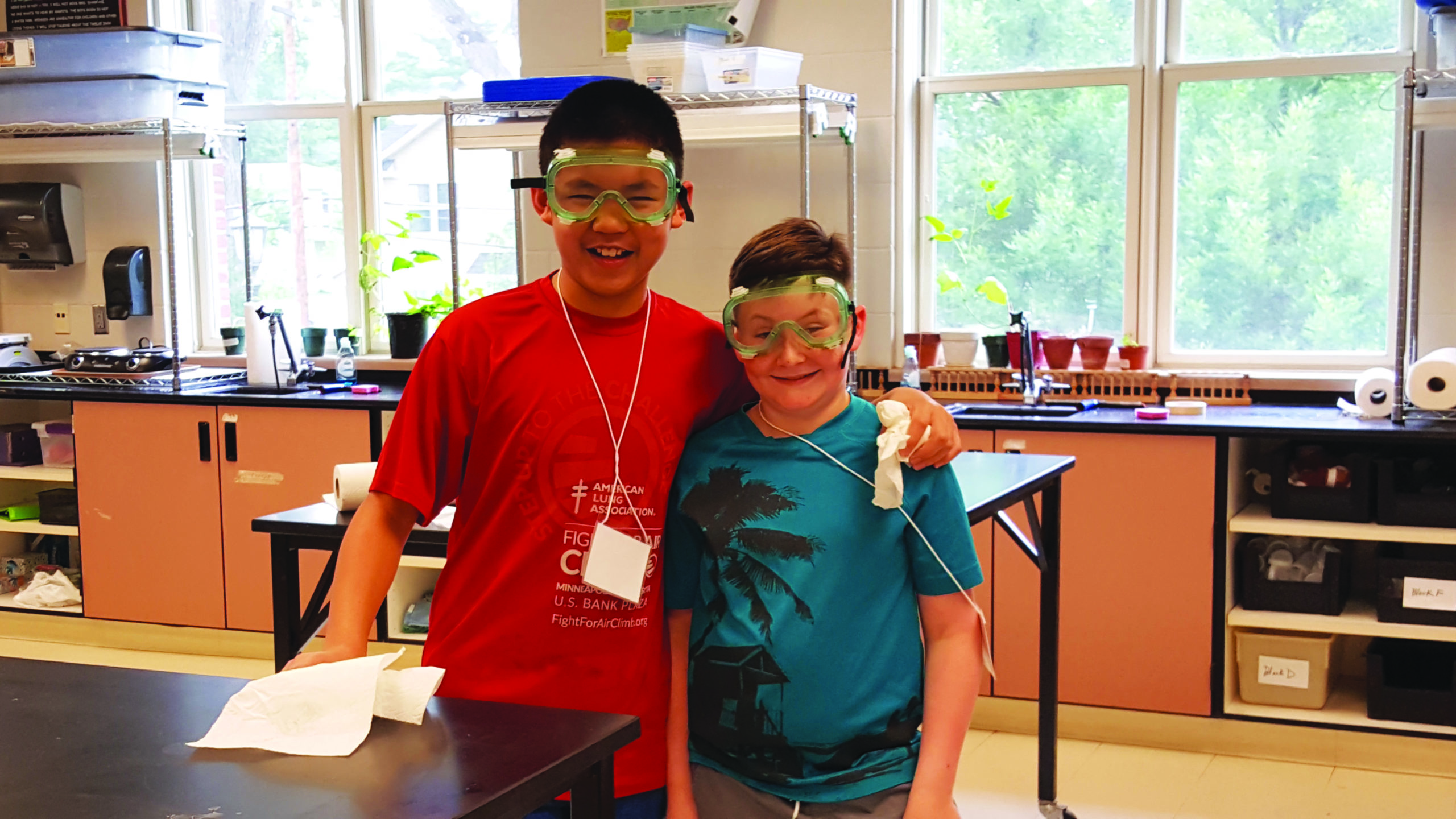 Creating Cool Chemistry ExplorSchool students with protective eye wear standing and smiling
