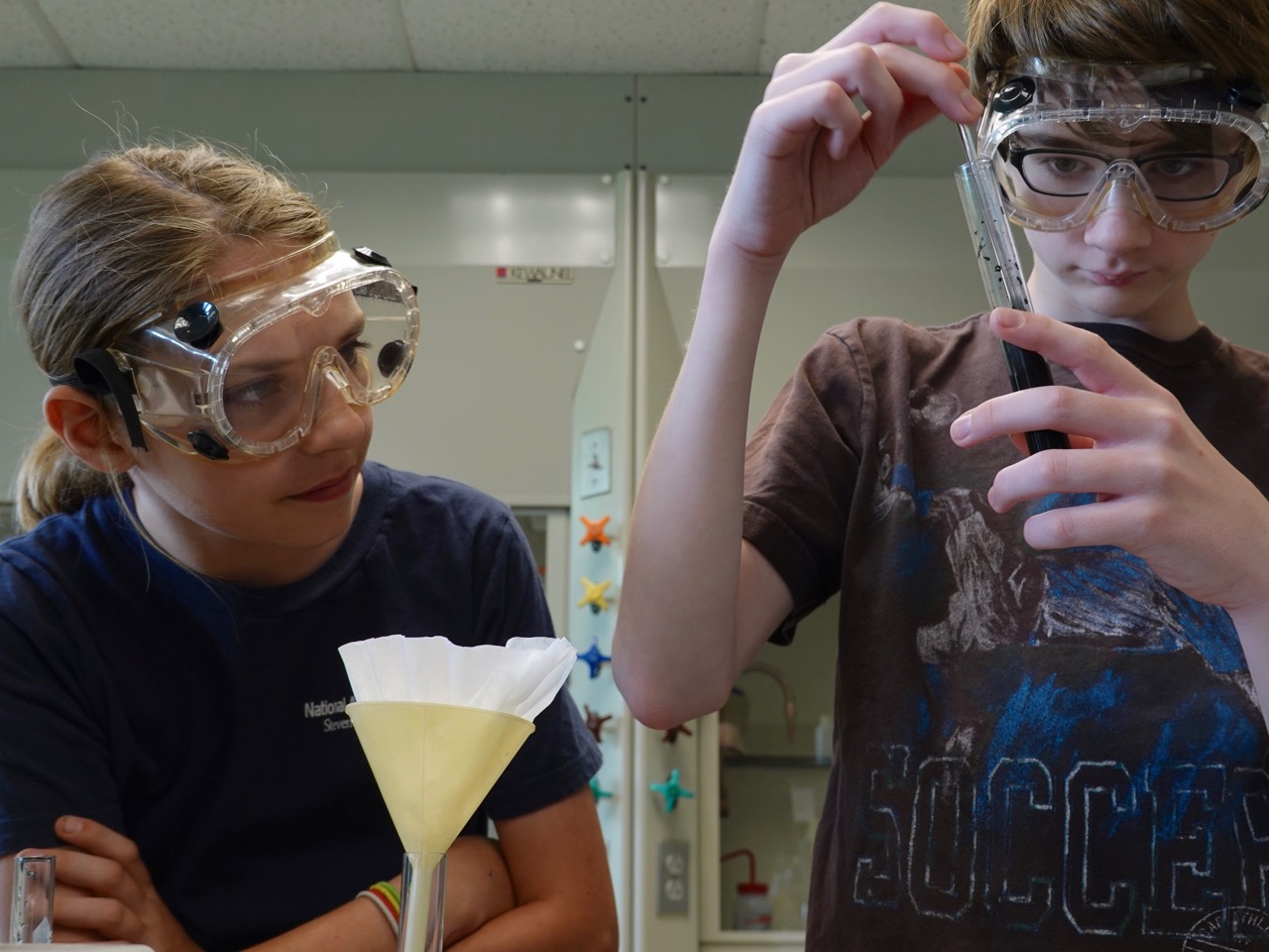 Chemistry is a Blast ExplorSchool students doing experiment with goggles on